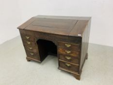 AN C18TH OAK SLOPED TOP KNEEHOLE DESK WITH FITTED INTERIOR AND EIGHT DRAWERS - D 120CM. W 68CM.