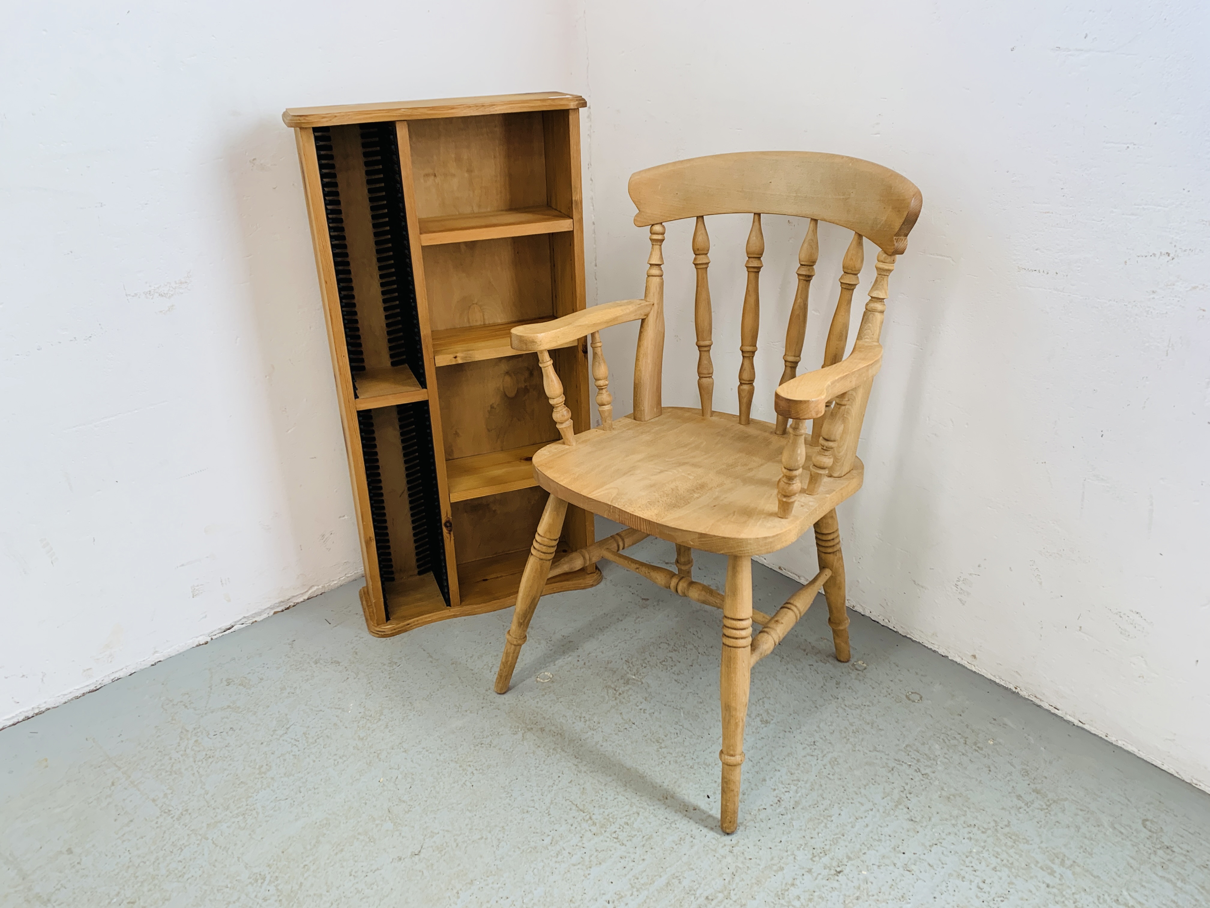 A BEECHWOOD TRADITIONAL ELBOW CHAIR AND WAXED PINE MEDIA STORAGE SHELF