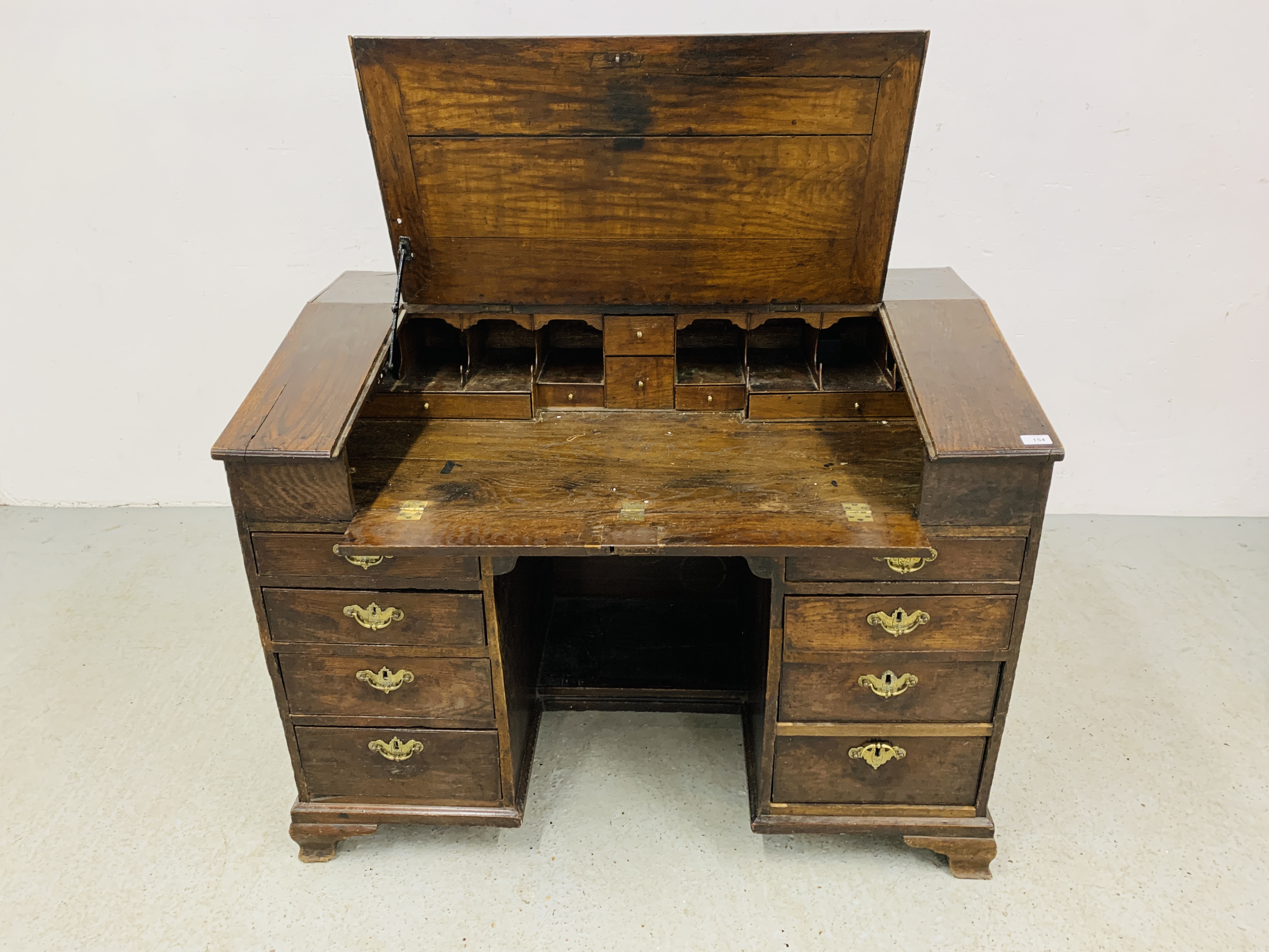 AN C18TH OAK SLOPED TOP KNEEHOLE DESK WITH FITTED INTERIOR AND EIGHT DRAWERS - D 120CM. W 68CM. - Image 5 of 15