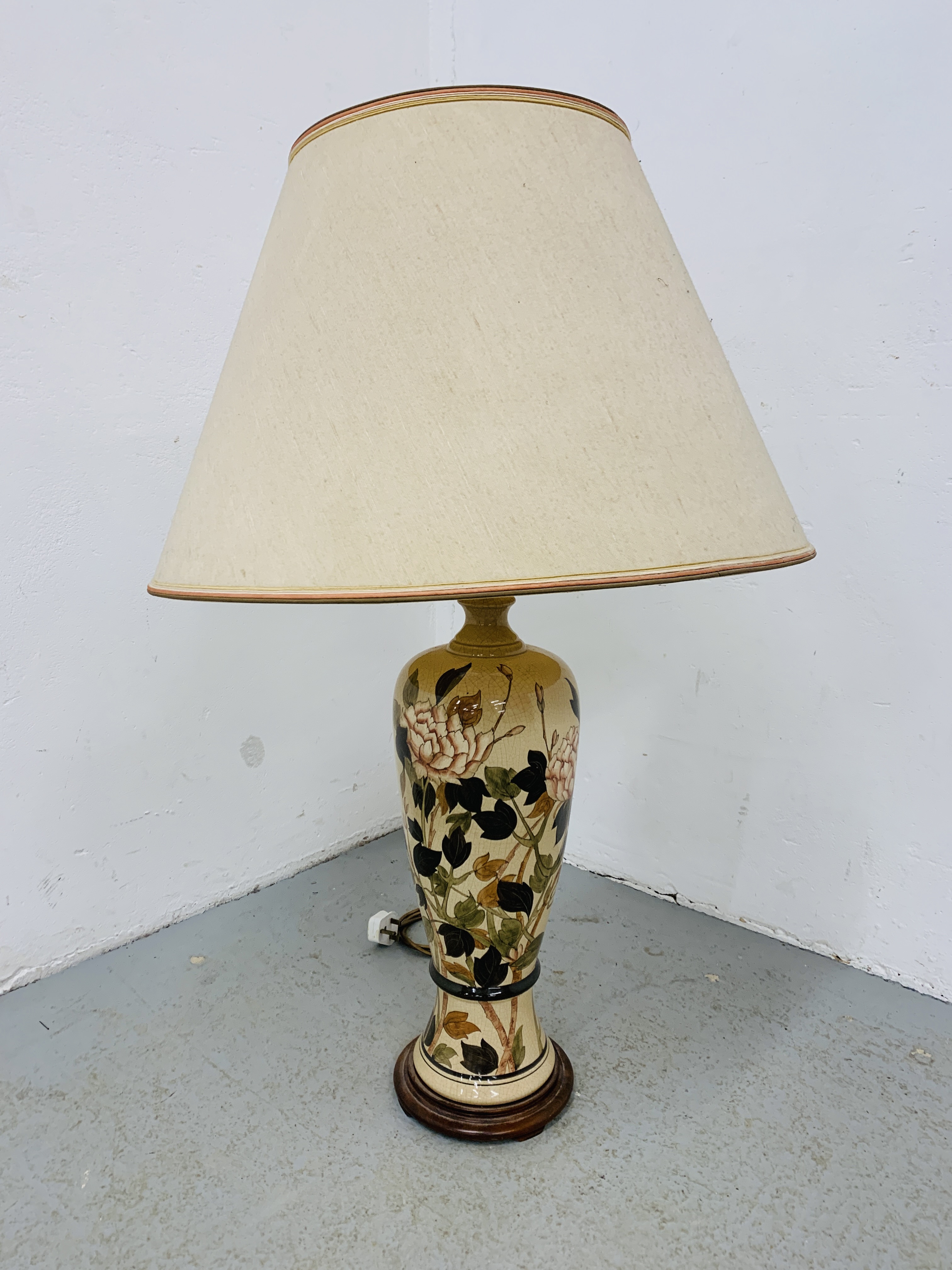 A LARGE FLORAL DECORATED POTTERY TABLE LAMP WITH SHADE - SOLD AS SEEN