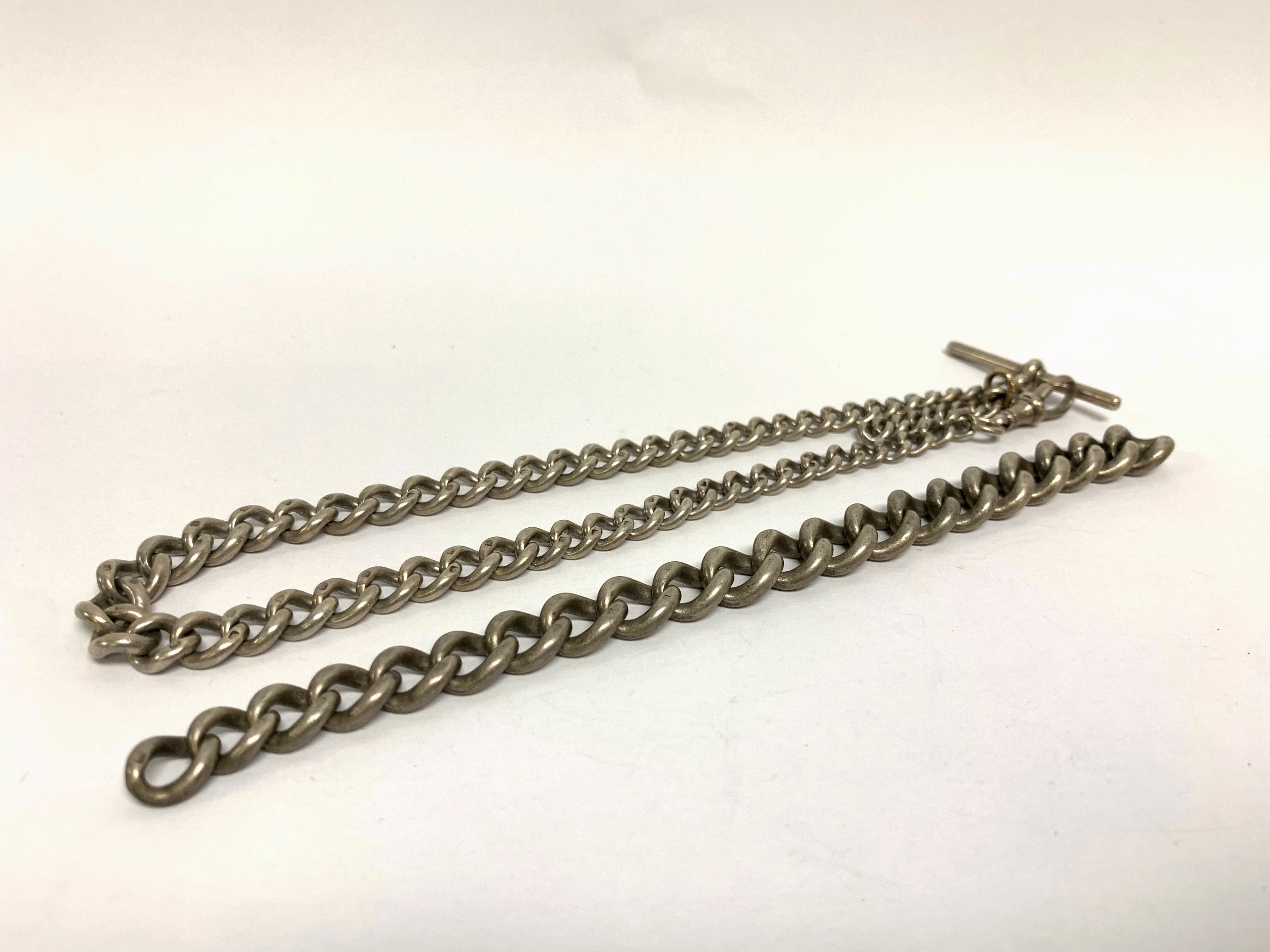 A SILVER WATCH CHAIN ALONG WITH A BROKEN SILVER CHAIN (75g in total)