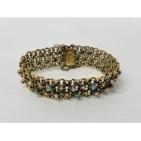 A 9CT GOLD BRACELET SET WITH ALTERNATING TURQUOISE AND PEARLS