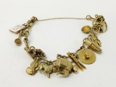 A 9CT GOLD CHARM BRACELET WITH TWELVE CHARMS ATTACHED
