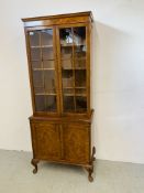 A REPRODUCTION BOOKCASE WITH CABINET TO BASE - W 71CM. H 173CM. D 37CM.