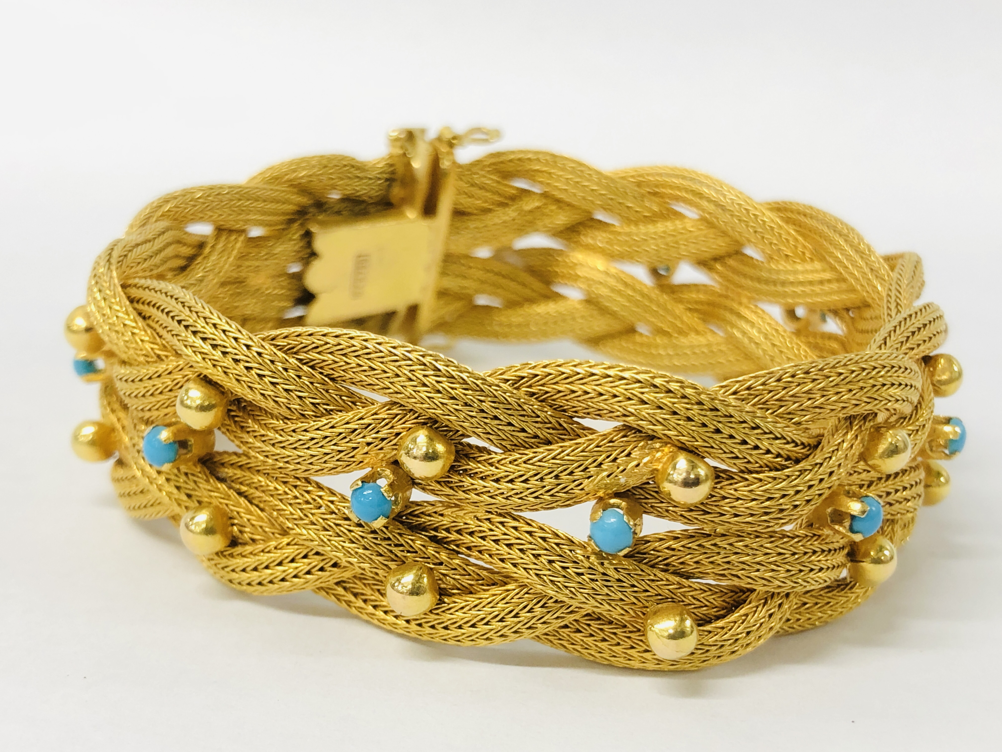 A ROPE TWIST BRACELET SET WITH TINY TURQUOISE STONES, THE CLASP MARKED 750.