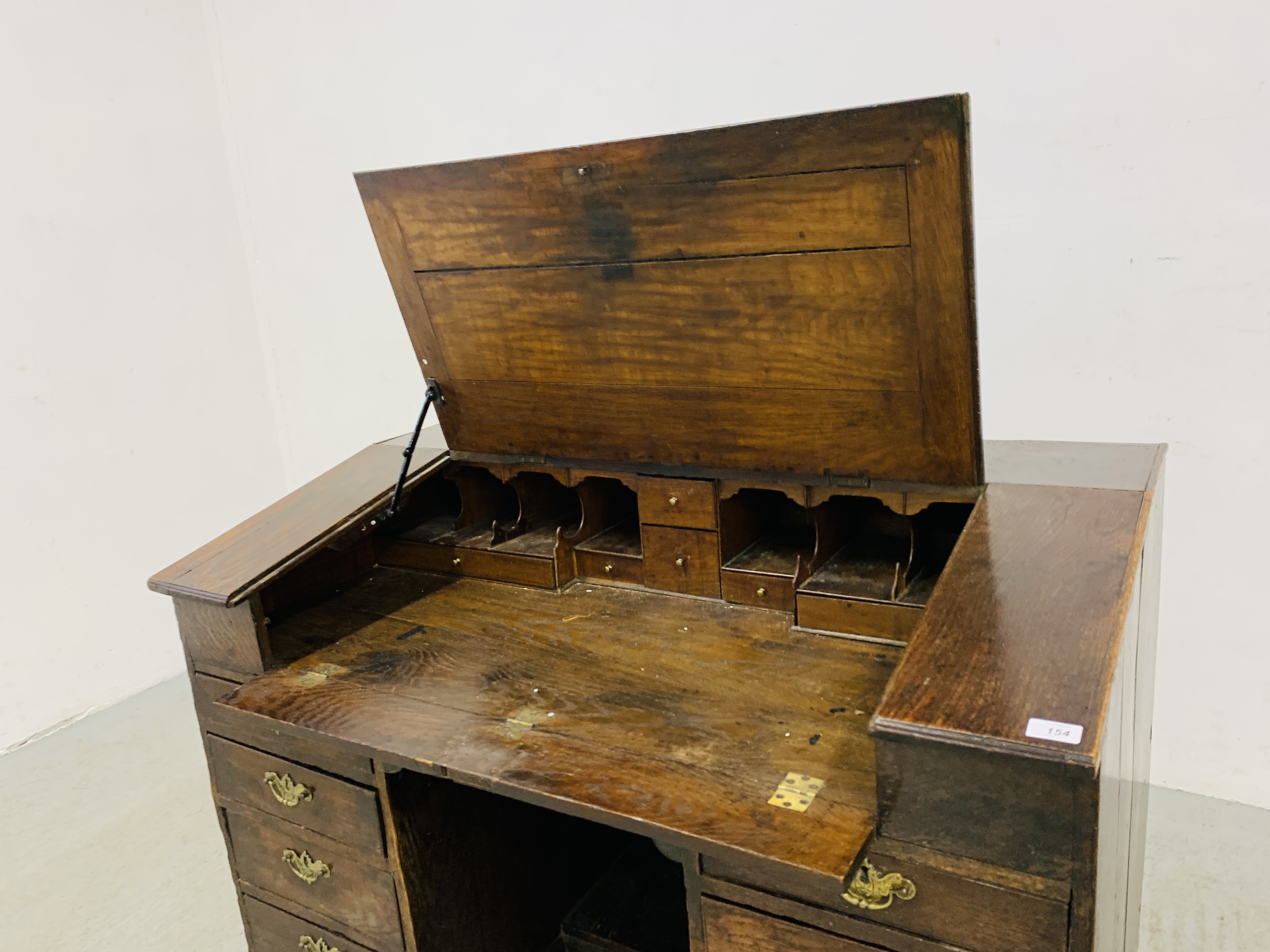 AN C18TH OAK SLOPED TOP KNEEHOLE DESK WITH FITTED INTERIOR AND EIGHT DRAWERS - D 120CM. W 68CM. - Image 6 of 15