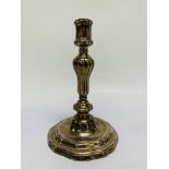 A CONTINENTAL CAST SILVER CANDLESTICK, THE GADROONED COLUMN ON A STEPPED AND SCROLLED BASE - 21.