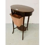 AN EDWARDIAN MAHOGANY TWO TIER WORK TABLE OF OVAL FORM ON SPLAYED LEG,