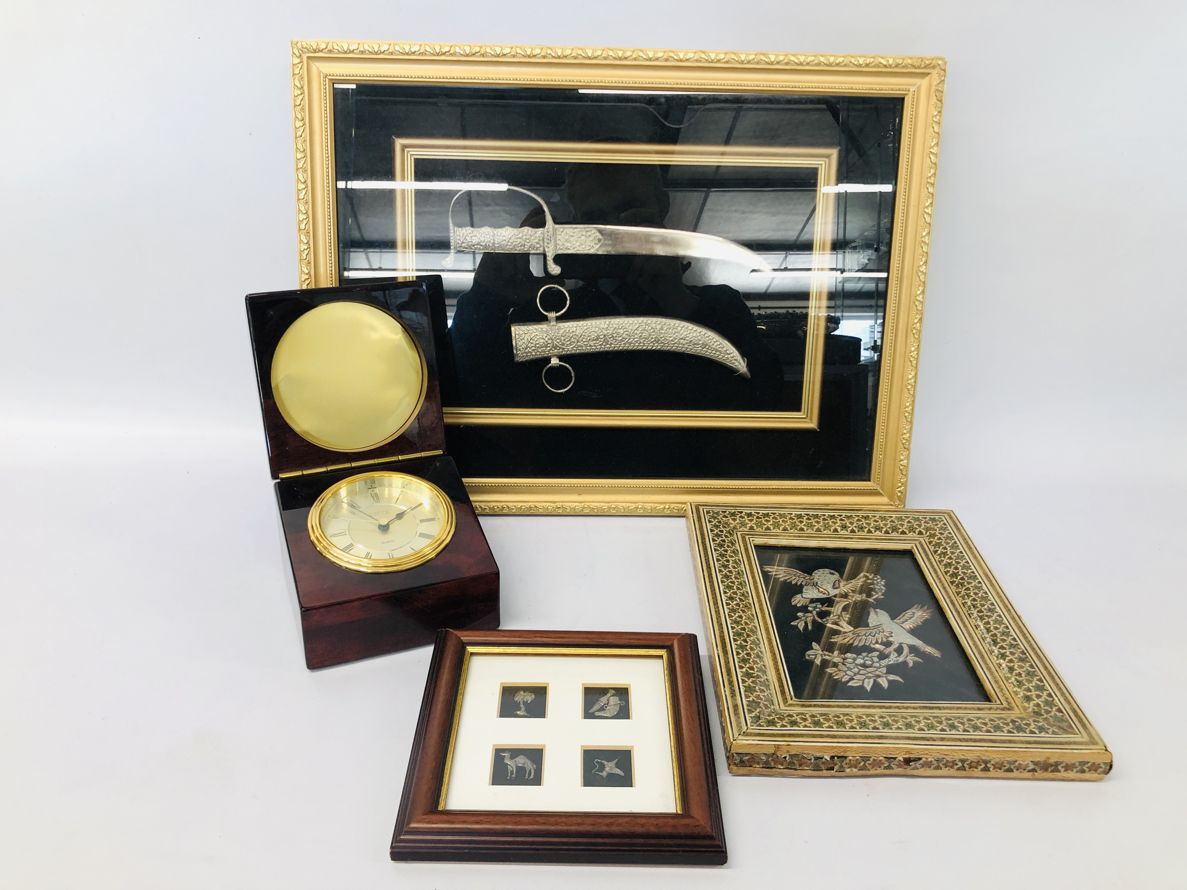 CASED DISPLAY OF AN ARAB DECORATIVE SWORD, FRAMED METAL WORK BIRDS, FRAMED MINIATURE CHARMS,