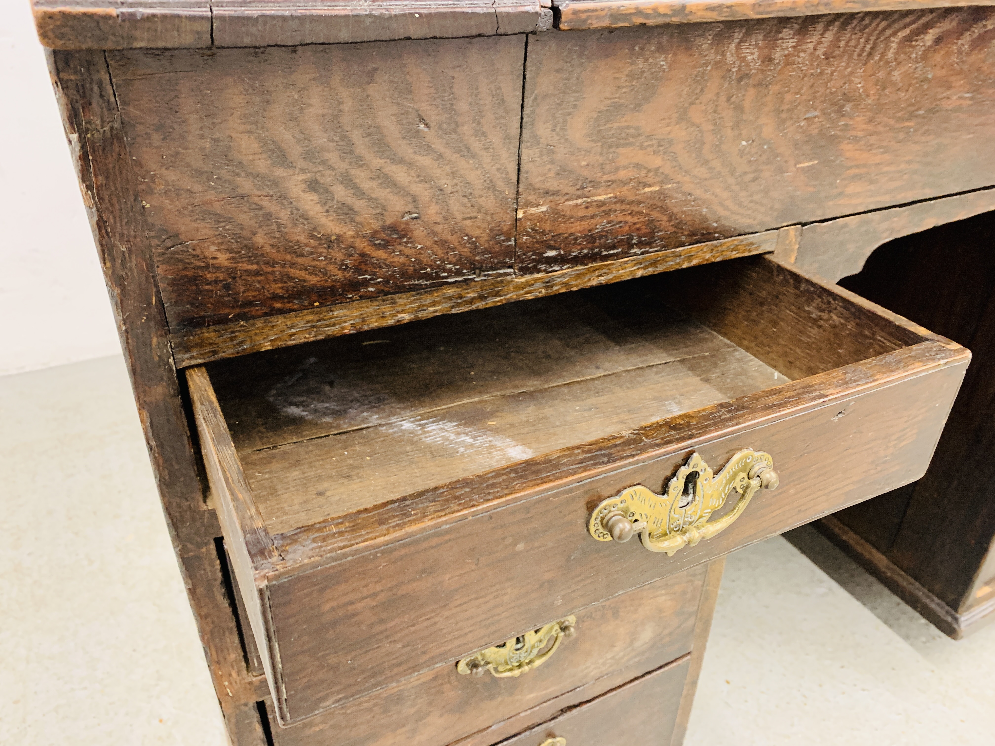 AN C18TH OAK SLOPED TOP KNEEHOLE DESK WITH FITTED INTERIOR AND EIGHT DRAWERS - D 120CM. W 68CM. - Image 10 of 15