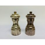 A SILVER PEPPER AND A SILVER SALT GRINDER OF SIMILAR CIRCULAR SHAPE,