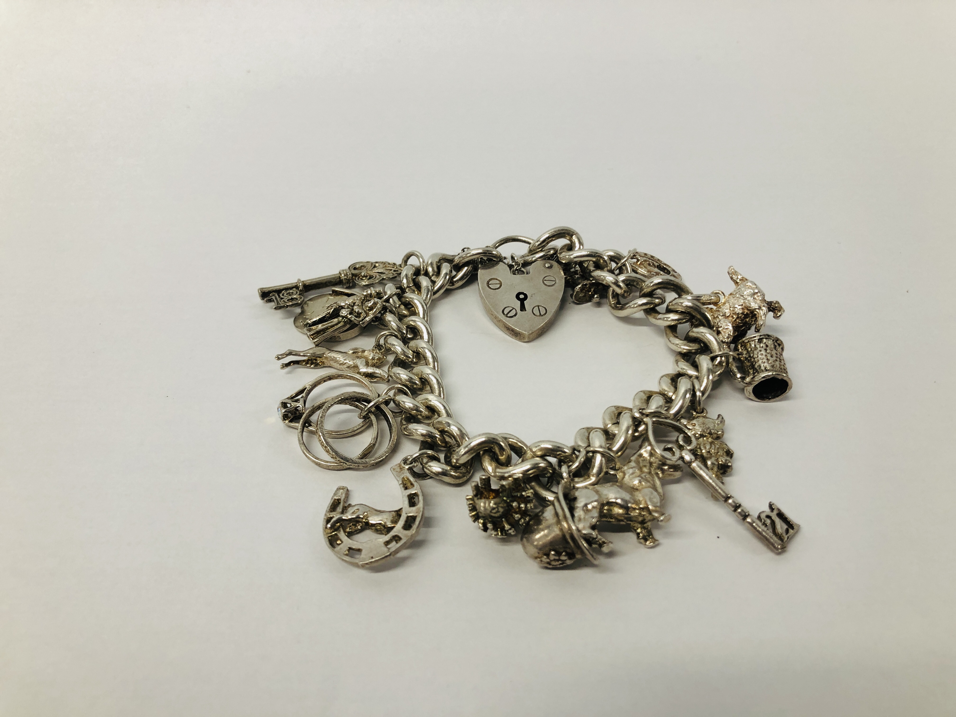 SILVER CHARM BRACELET (15 CHARMS ATTACHED)