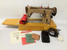 A SINGER ELECTRIC SEWING MACHINE WITH FOOT PEDAL AND ACCESSORIES - SOLD AS SEEN