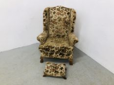 A WING BACK FIRE SIDE CHAIR UPHOLSTERED IN FLORAL BROCADE,