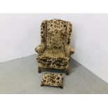 A WING BACK FIRE SIDE CHAIR UPHOLSTERED IN FLORAL BROCADE,