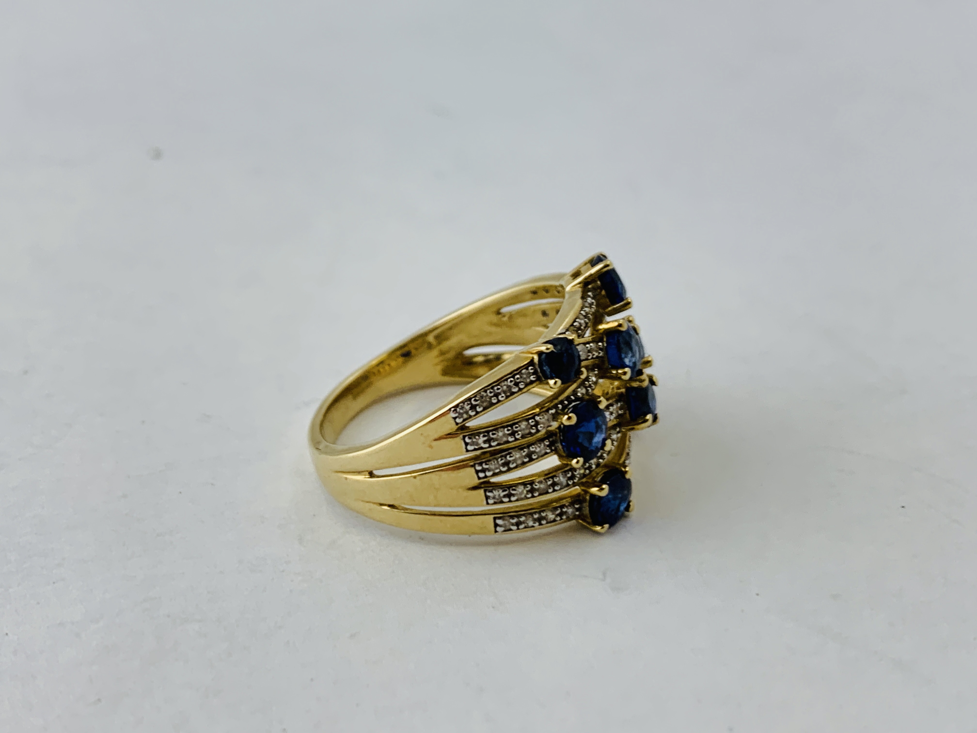 A 9CT GOLD DESIGNER WOVEN STRAND RING SET WITH 8 PRINCIPAL BLUE STONES THE STRANDS ENCRUSTED WITH - Image 2 of 7