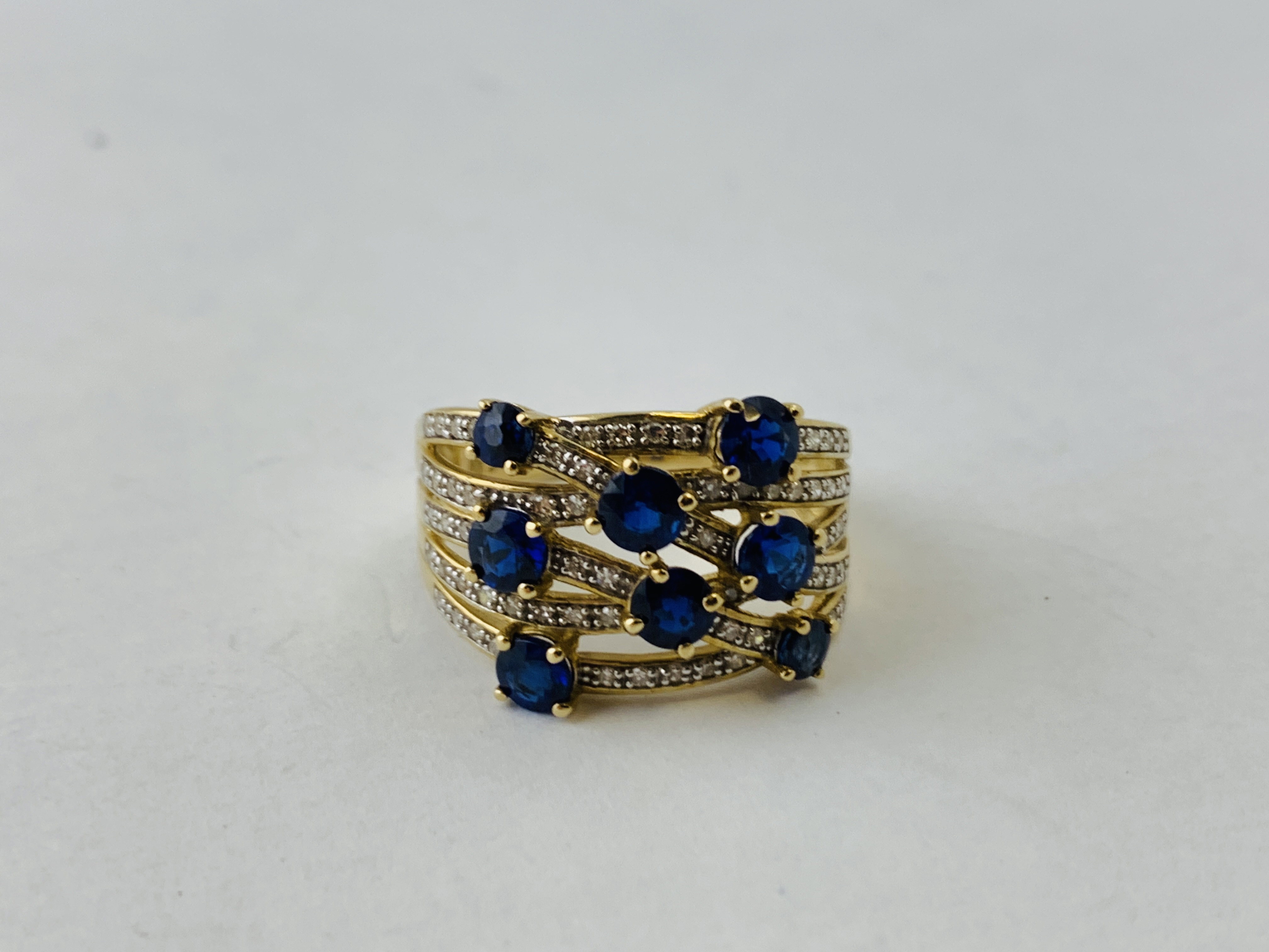 A 9CT GOLD DESIGNER WOVEN STRAND RING SET WITH 8 PRINCIPAL BLUE STONES THE STRANDS ENCRUSTED WITH - Image 3 of 7