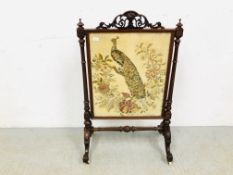 A VICTORIAN MAHOGANY FIRE SCREEN WITH HAND EMBROIDERED PEACOCK PANEL - W 72CM. H 116CM.