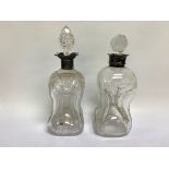 2 SIMILAR SILVER DECANTERS OF WAISTED FORM, WITH SILVER COLLARS,
