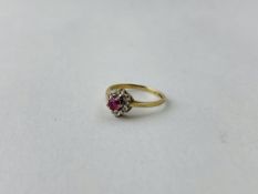 A 9CT GOLD DIAMOND AND RUBY SET FLOWER HEAD RING