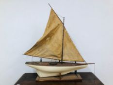 AN ANTIQUE MODEL POND YACHT - LENGTH 106CM. HEIGHT 120CM.