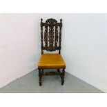 A HEAVILY CARVED OAK SIDE CHAIR WITH TAN LEATHER SEAT