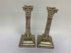 A PAIR OF SILVER CANDLESTICKS OF CORINTHIAN COLUMN FORM, FILLED, RUBBED MARKS ILLEGIBLE,