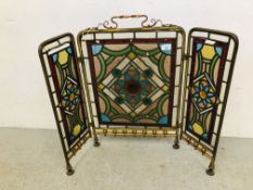 AN ANTIQUE VICTORIAN BRASS FOLDING FIRE SCREEN WITH LEADED STAINED PANEL DETAIL (SOME LOSSES)
