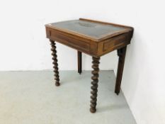 A VICTORIAN WRITING TABLE STANDING ON BARLEY TWIST LEGS,