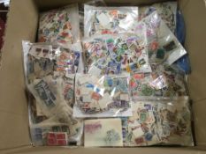 LARGE BOX MANY THOUSANDS STAMPS IN BAGS AND LOOSE