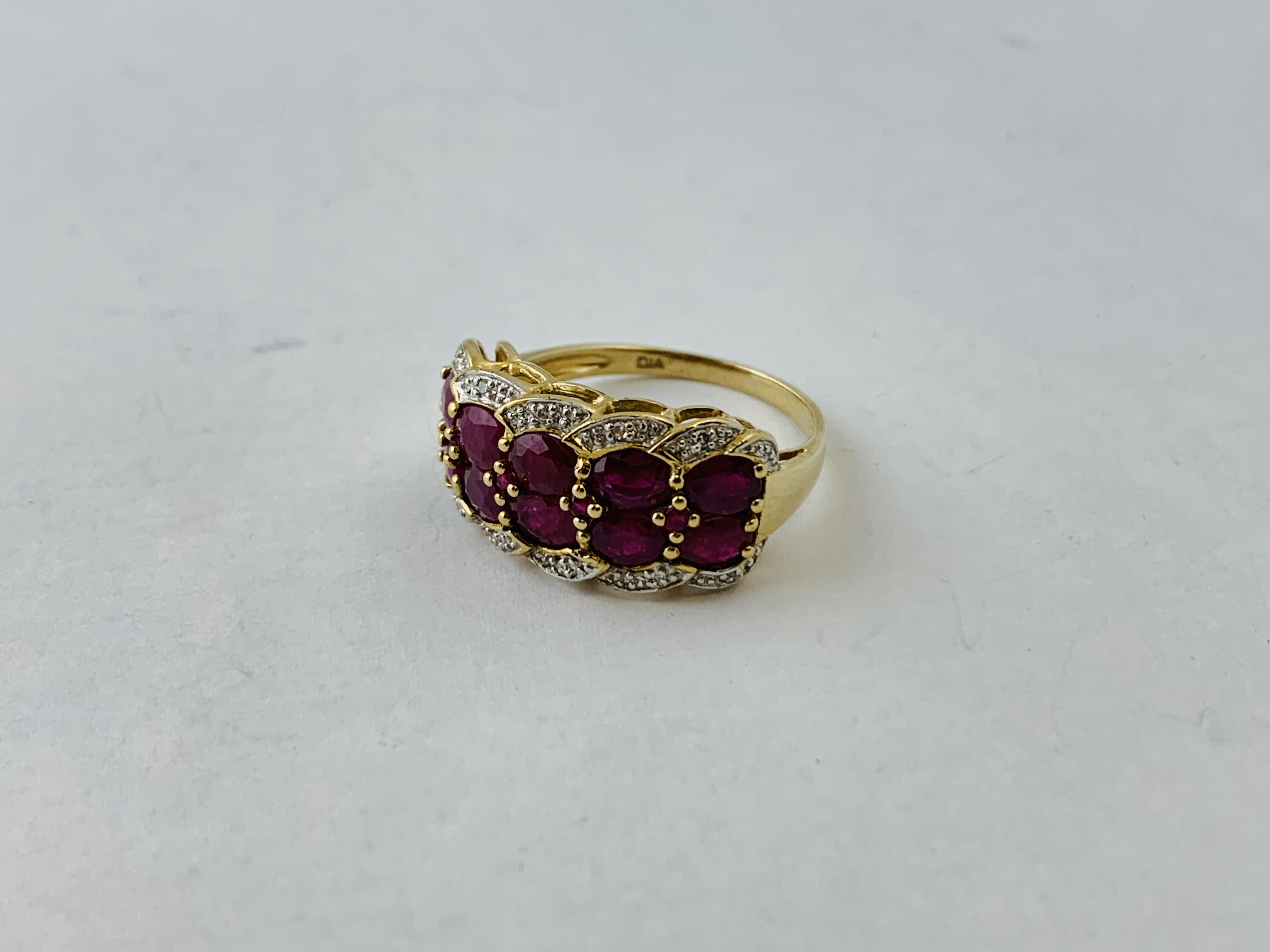 LADIES 9CT GOLD RUBY AND DIAMOND RING THE 10 PRINCIPLE RUBY'S SURROUNDED BY DIAMOND CHIPS SIZE Q/R