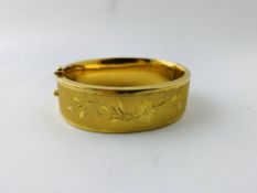 A YELLOW METAL HINGED BANGLE INDISTINCT MARKS