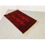 RED / BLACK EASTERN PATTERNED RUG - 145CM X 100CM.