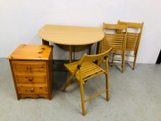 AN OAK FINISH COMPACT DROP LEAF DINING TABLE AND THREE FOLDING CHAIRS PLUS A PINE THREE DRAWER