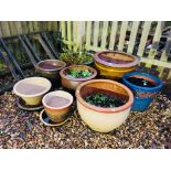 A GROUP OF EIGHT VARIOUS GLAZED GARDEN PLANTERS THE LARGEST DIAMETER 53CM,