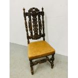 A HEAVILY CARVED OAK SIDE CHAIR WITH TAN LEATHER SEAT