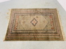 A PERSIAN RUG THE CENTRAL LOZENGE ON A BEIGE FIELD 122CM X 174CM.