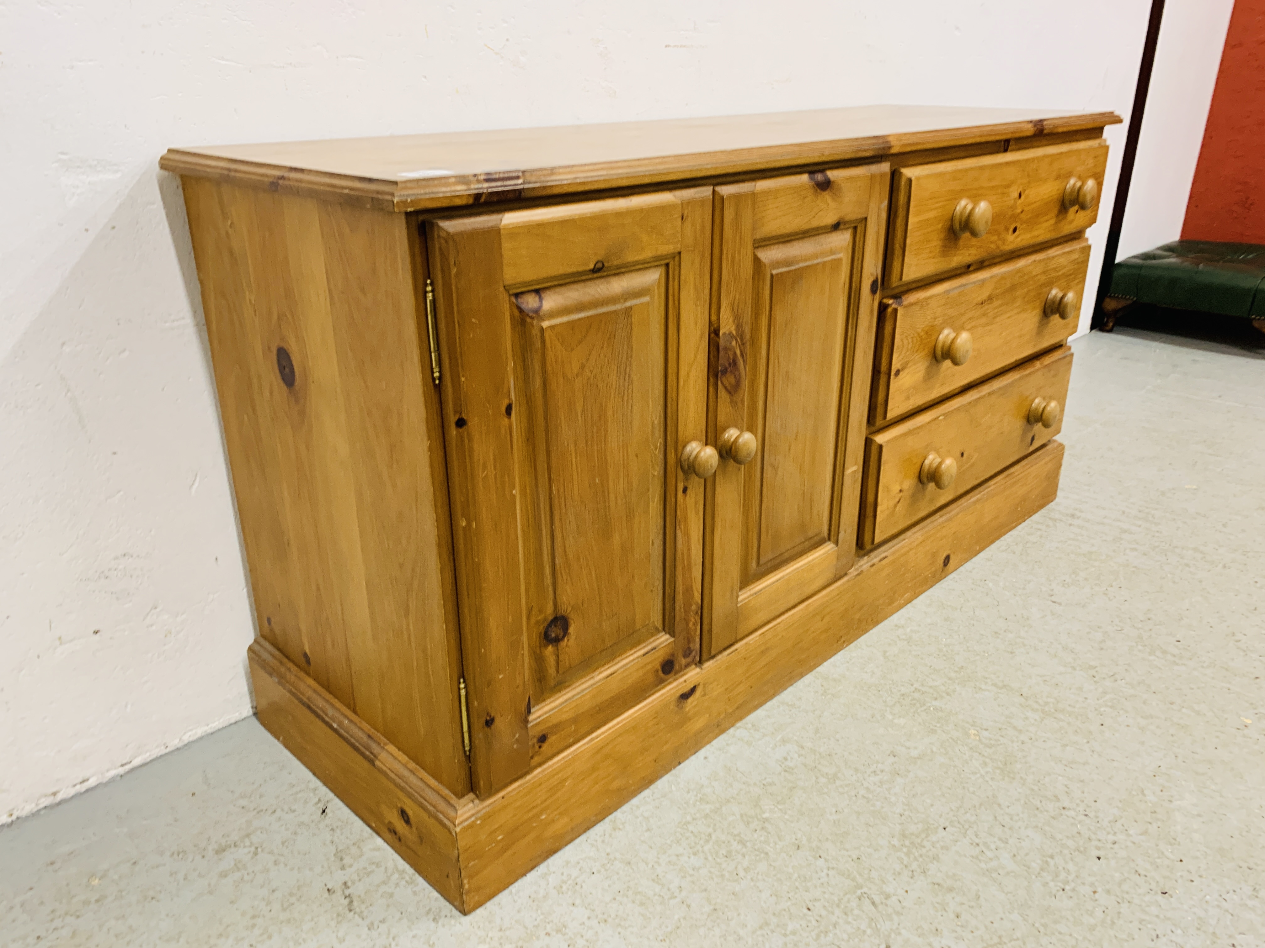 A SOLID HONEY PINE THREE DRAWER DRESSER BASE WITH CABINET TO ONE END - W 130CM. D 41CM. H 66CM. - Image 7 of 9