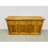 A SOLID WAXED PINE THREE DRAWER DRESSER BASE WITH THREE CABINET DOORS BELOW - W 172CM. D 51CM.
