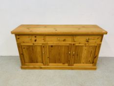 A SOLID WAXED PINE THREE DRAWER DRESSER BASE WITH THREE CABINET DOORS BELOW - W 172CM. D 51CM.