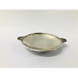 A GEORG JENSEN DANISH SILVER DISH OF SHALLOW FORM - DIAMETER 103MM WITH SHELL SHAPED HANDLES