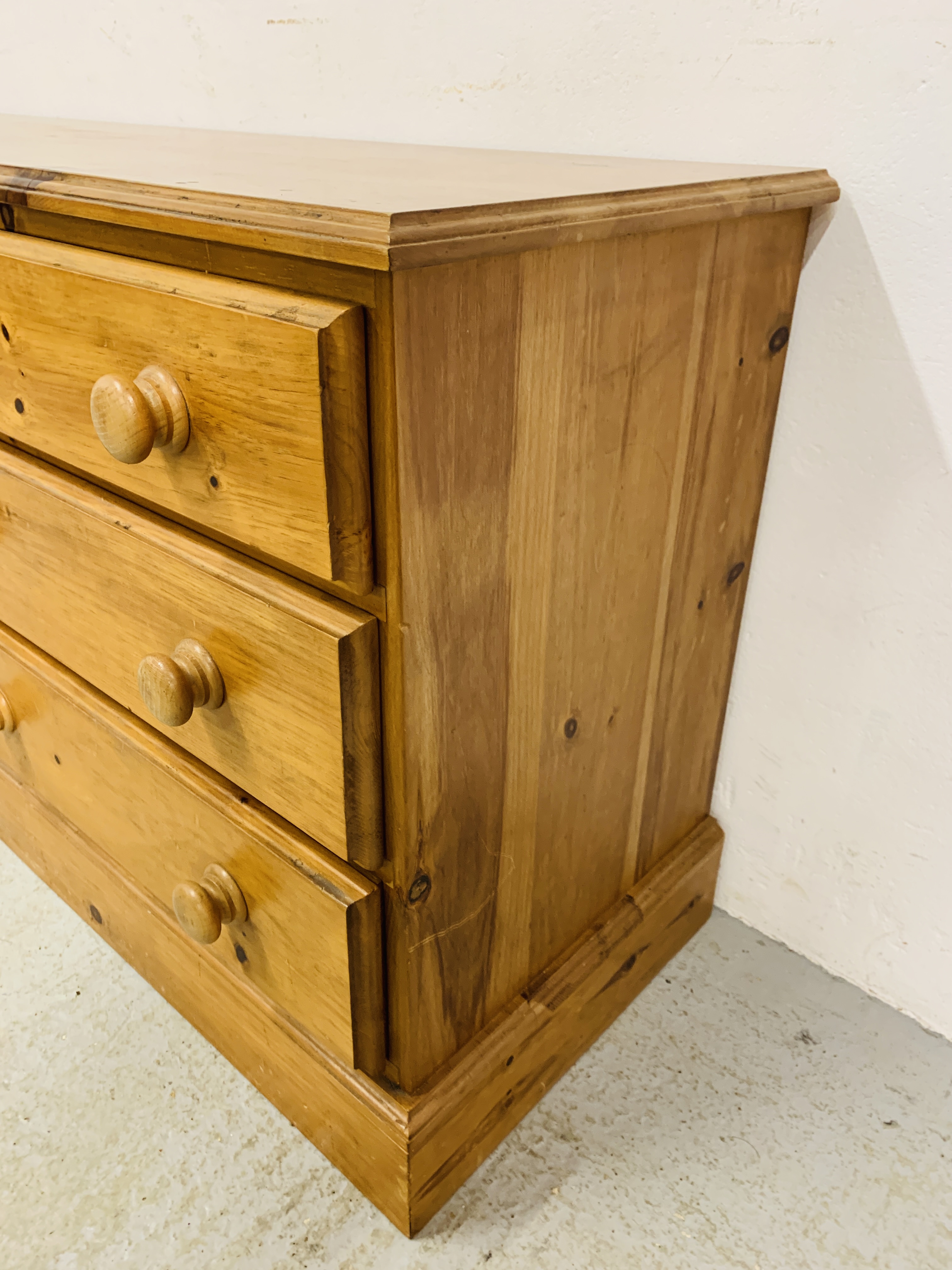 A SOLID HONEY PINE THREE DRAWER DRESSER BASE WITH CABINET TO ONE END - W 130CM. D 41CM. H 66CM. - Image 6 of 9