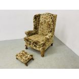 A WING BACK FIRE SIDE CHAIR UPHOLSTERED IN FLORAL BROCADE,