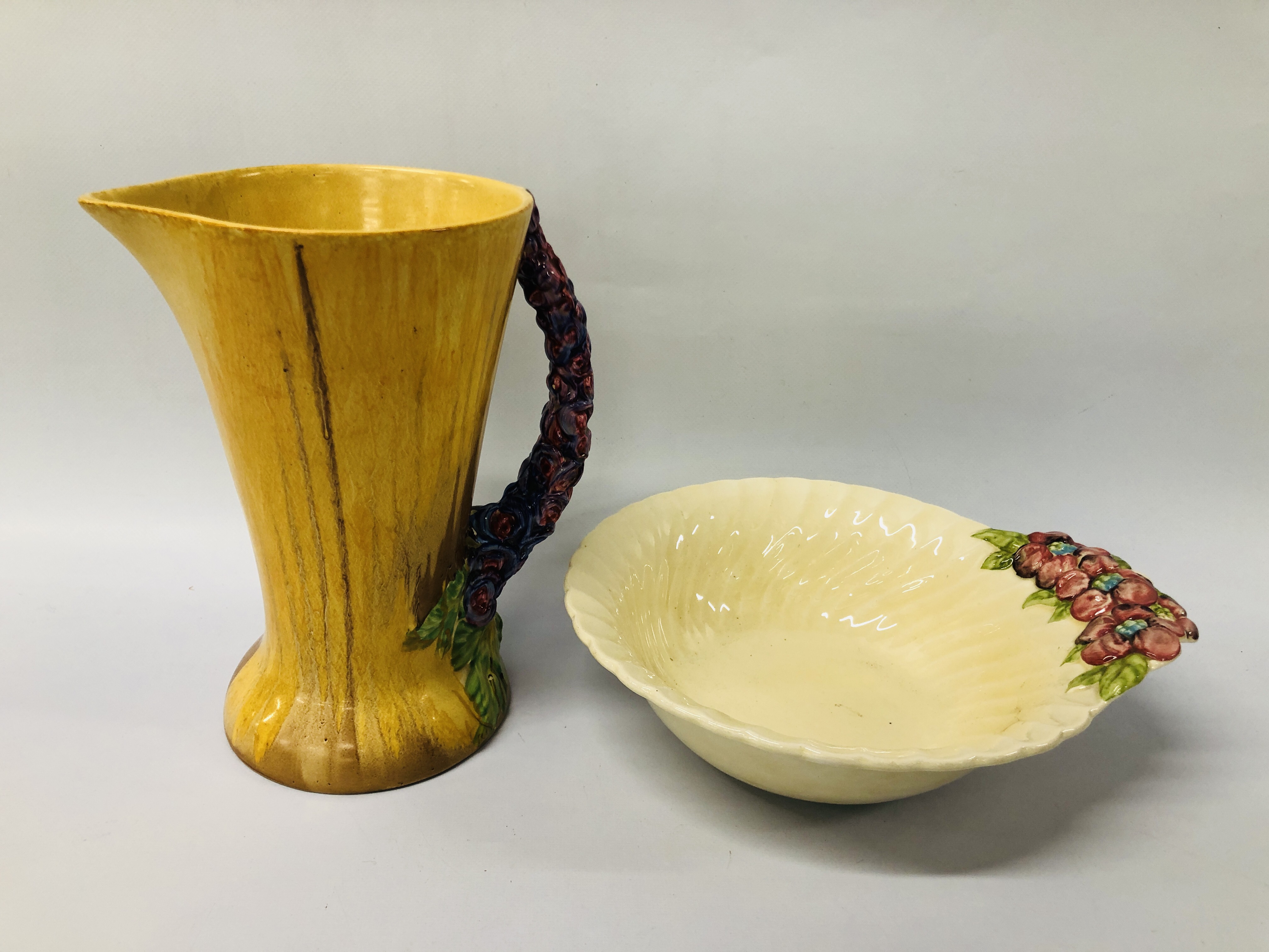 A CLARICE CLIFF BOWL ALONG WITH A CLARICE CLIFF JUG A/F.