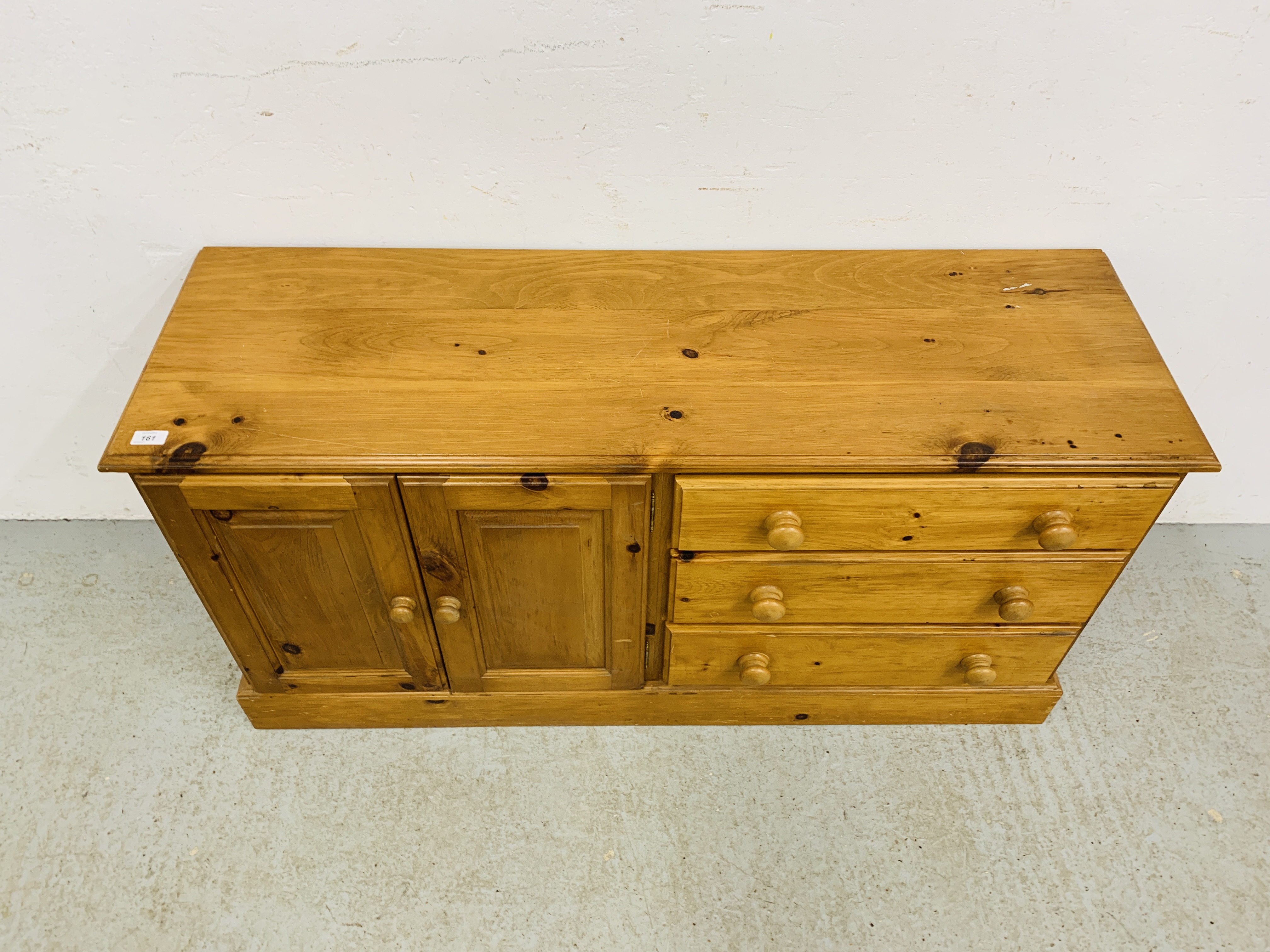 A SOLID HONEY PINE THREE DRAWER DRESSER BASE WITH CABINET TO ONE END - W 130CM. D 41CM. H 66CM. - Image 2 of 9