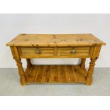 A SOLID WAXED PINE TWO DRAWER SIDE TABLE WITH HEAVY TURNED SUPPORTS - W 127CM. D 50CM. H 77CM.