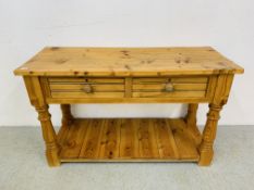 A SOLID WAXED PINE TWO DRAWER SIDE TABLE WITH HEAVY TURNED SUPPORTS - W 127CM. D 50CM. H 77CM.