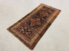 PERSIAN RUG, THE TWO CENTRAL LOZENGES ON A DARK BLUE FIELD,