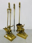 A PAIR OF HEAVY BRASS FIRE DOGS IN THE FORM OF WYVERNS ALONG WITH A SET OF THREE BRASS FIRE IRONS