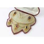 AN EARRING AND NECKLACE SET WITH PEAR SHAPED AMETHYST CABOCHONS,